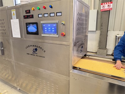 Drying of agricultural products such as corn residue using microwave equipment